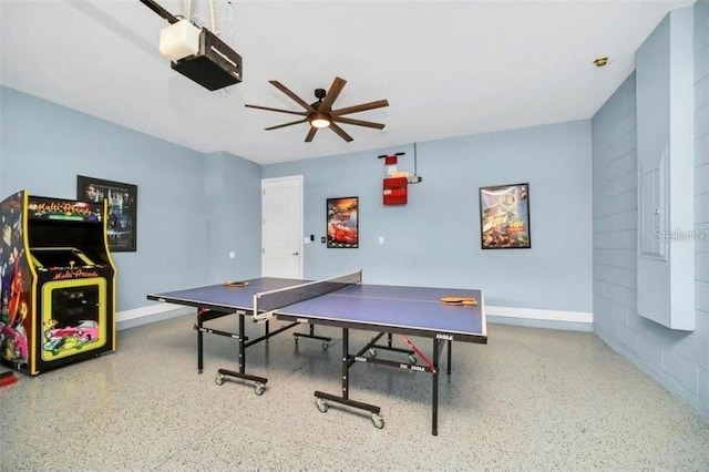 rec room featuring speckled floor, baseboards, and ceiling fan