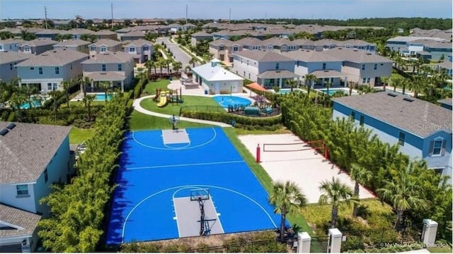 view of basketball court with community basketball court, fence, and a residential view