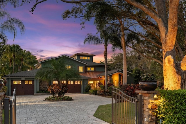 7849 Georgeann St, Winter Park, FL 32792 - view of front facade with decorative driveway, a gate, and stucco siding