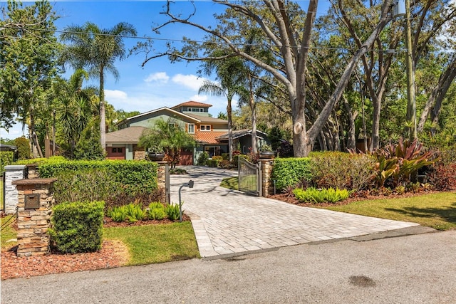 7849 Georgeann St, Winter Park, FL 32792 - view of front of property with decorative driveway and a gate