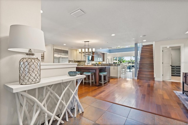 7849 Georgeann St, Winter Park, FL 32792 - kitchen featuring stainless steel built in refrigerator, a kitchen breakfast bar, recessed lighting, a peninsula, and a sink