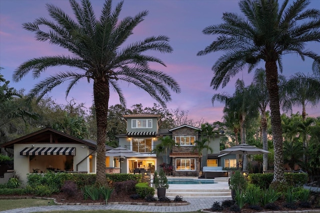 7849 Georgeann St, Winter Park, FL 32792 - view of front of house with stucco siding and an outdoor pool