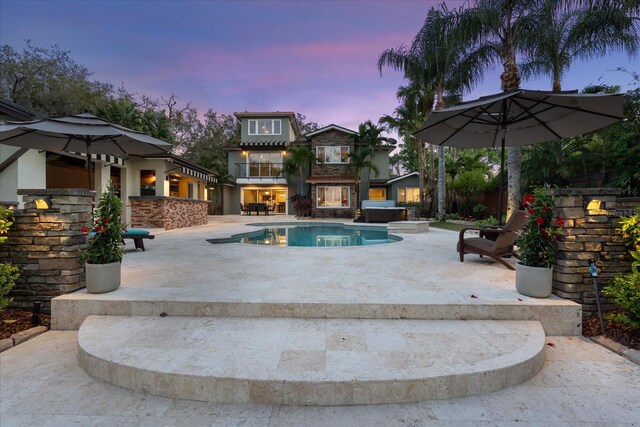 7849 Georgeann St, Winter Park, FL 32792 - pool at dusk featuring a patio area and an outdoor pool