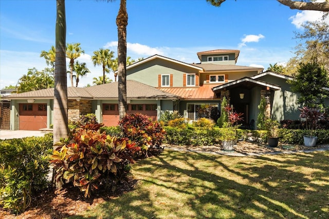 7849 Georgeann St, Winter Park, FL 32792 - view of front of home with an attached garage, a standing seam roof, a front lawn, and metal roof