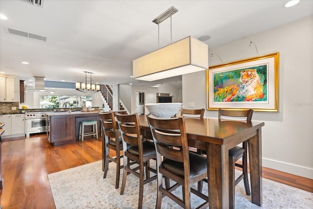 7849 Georgeann St, Winter Park, FL 32792 - dining space featuring wood finished floors, stairs, baseboards, and recessed lighting