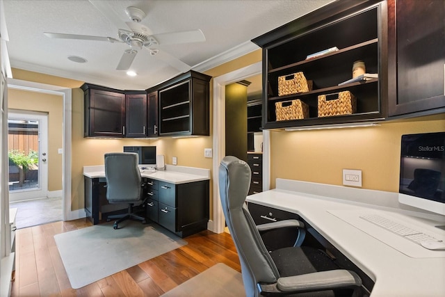 7849 Georgeann St, Winter Park, FL 32792 - office with ceiling fan, wood finished floors, built in desk, baseboards, and crown molding