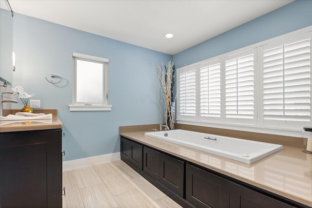 7849 Georgeann St, Winter Park, FL 32792 - full bath featuring vanity, a garden tub, baseboards, and recessed lighting