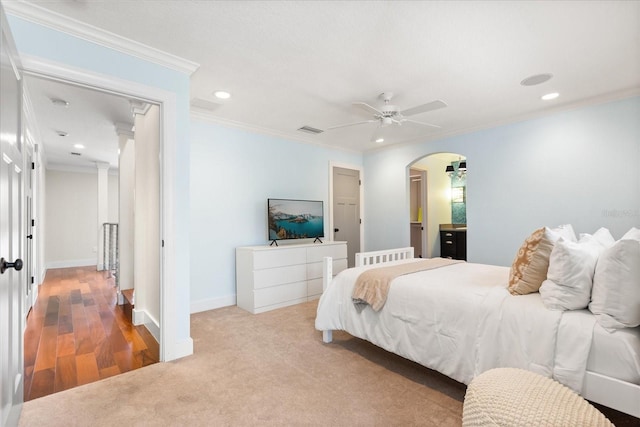 7849 Georgeann St, Winter Park, FL 32792 - carpeted bedroom with arched walkways, recessed lighting, crown molding, baseboards, and a ceiling fan