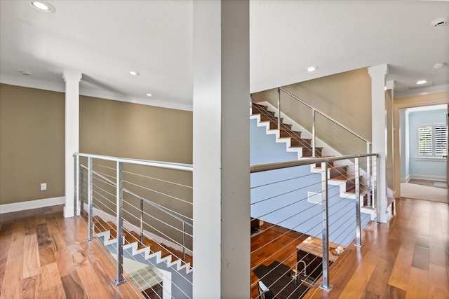 7849 Georgeann St, Winter Park, FL 32792 - staircase featuring decorative columns, baseboards, wood finished floors, and recessed lighting