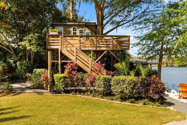 7849 Georgeann St, Winter Park, FL 32792 - rear view of house with a yard, a deck with water view, and stairway
