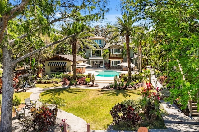 7849 Georgeann St, Winter Park, FL 32792 - back of property featuring a yard, an outdoor pool, stucco siding, and a patio