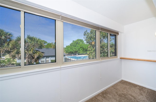 spare room featuring baseboards and carpet floors