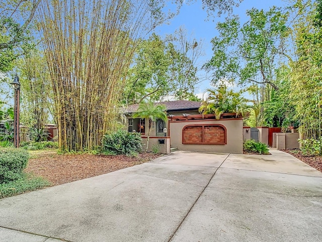 410 Sandspur Rd N, Maitland, FL 32751 - view of front of home featuring fence, driveway, stucco siding, and an attached garage