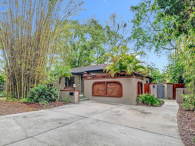 410 Sandspur Rd N, Maitland, FL 32751 - view of front of house with driveway, stucco siding, and an attached garage