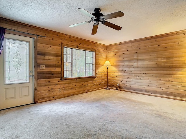 410 Sandspur Rd N, Maitland, FL 32751 - unfurnished room featuring a ceiling fan, carpet floors, wood walls, and a textured ceiling