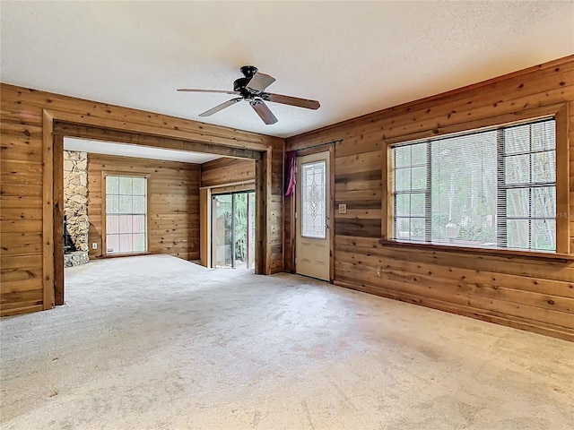 410 Sandspur Rd N, Maitland, FL 32751 - carpeted empty room featuring a textured ceiling, wood walls, and a ceiling fan