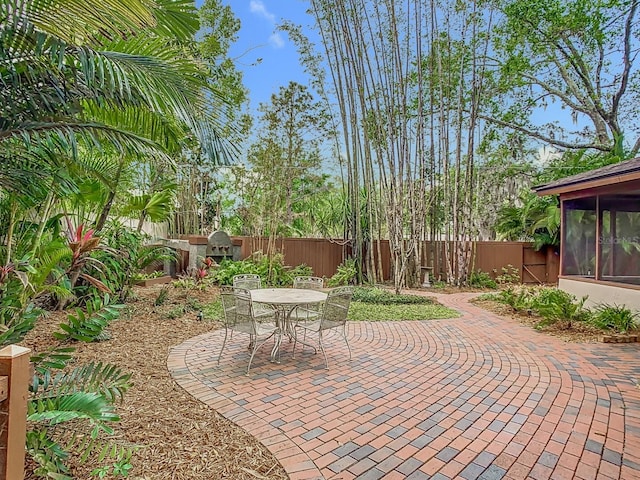 410 Sandspur Rd N, Maitland, FL 32751 - view of patio featuring a sunroom and a fenced backyard