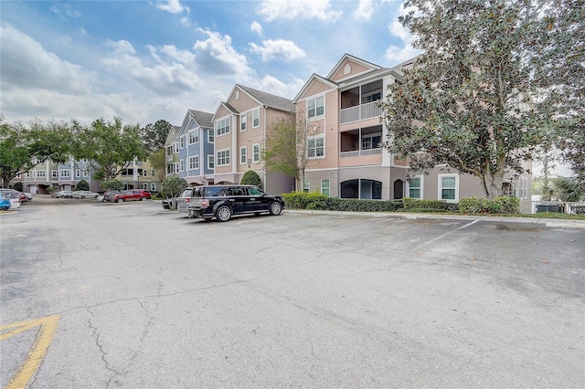 view of property featuring uncovered parking and a residential view