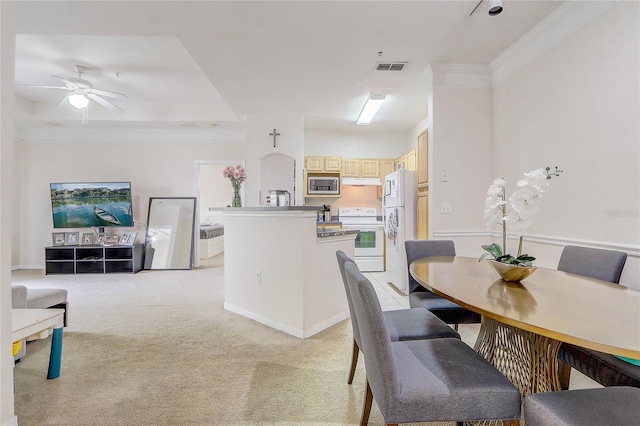 dining area with light carpet, visible vents, ornamental molding, and a ceiling fan