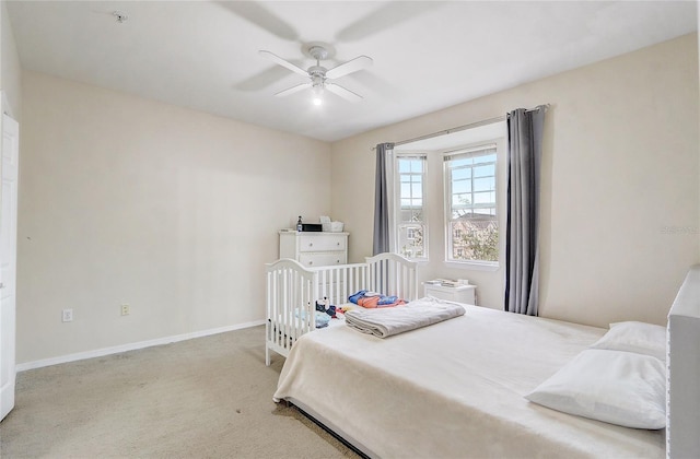 carpeted bedroom with baseboards and a ceiling fan