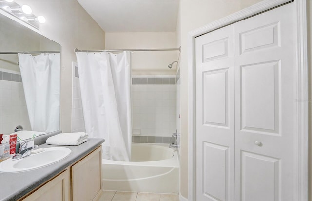 full bath featuring tile patterned floors, a closet, vanity, and shower / bath combo with shower curtain