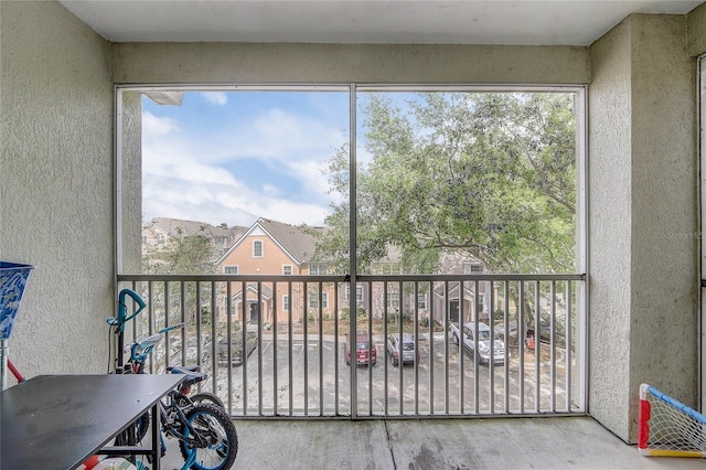 sunroom featuring a residential view