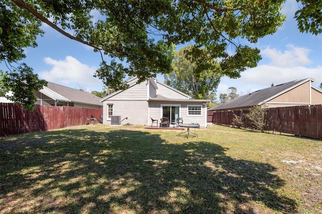 10724 Harkwood Blvd, Orlando, FL 32817 - back of property with central air condition unit, a patio, a yard, and a fenced backyard