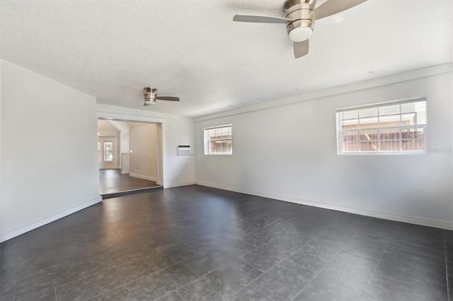 10724 Harkwood Blvd, Orlando, FL 32817 - spare room featuring baseboards, a ceiling fan, and a textured ceiling