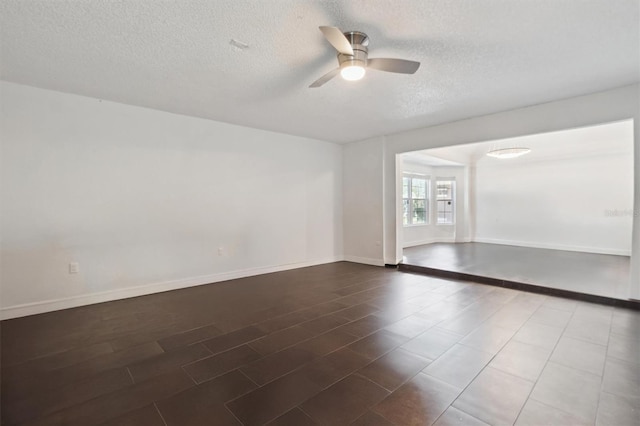 10724 Harkwood Blvd, Orlando, FL 32817 - spare room with a textured ceiling, wood finished floors, baseboards, and a ceiling fan