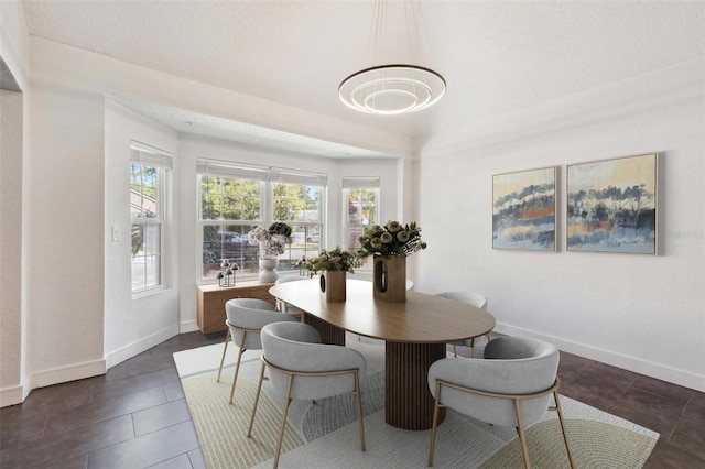 10724 Harkwood Blvd, Orlando, FL 32817 - dining space featuring baseboards, plenty of natural light, and a textured ceiling