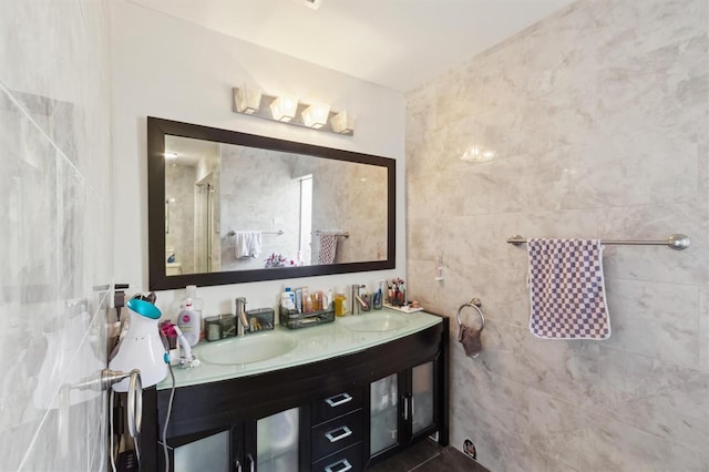 10724 Harkwood Blvd, Orlando, FL 32817 - full bathroom featuring a shower with shower door, double vanity, tile walls, and a sink