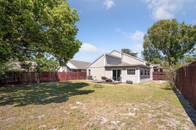 10724 Harkwood Blvd, Orlando, FL 32817 - rear view of house with a yard, central AC, and a fenced backyard