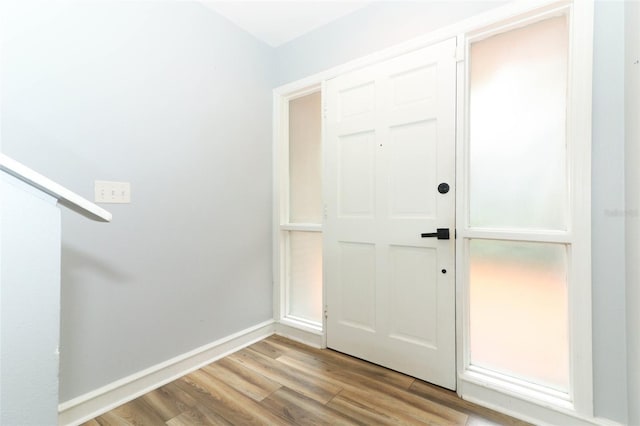 foyer featuring baseboards and light wood finished floors