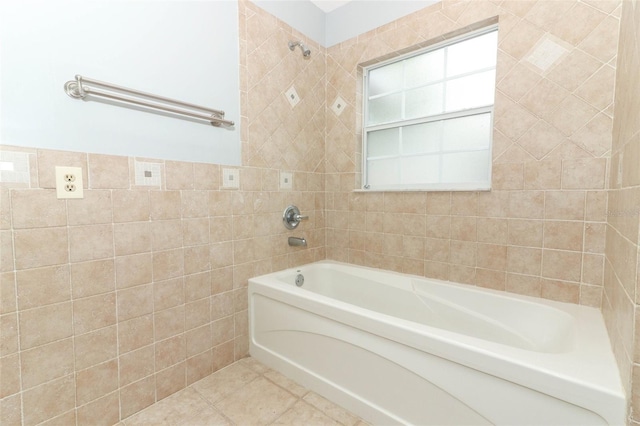 bathroom featuring a tub to relax in, tile patterned flooring, and tile walls