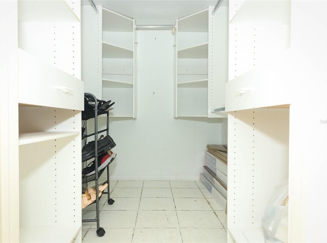 walk in closet with light tile patterned flooring