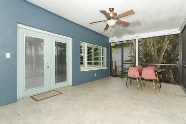sunroom / solarium with french doors and a ceiling fan
