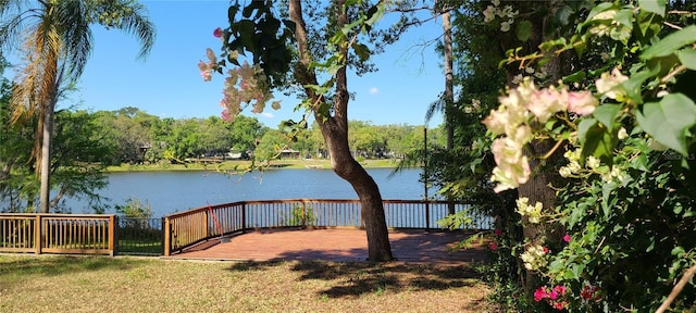 view of yard with a water view and fence