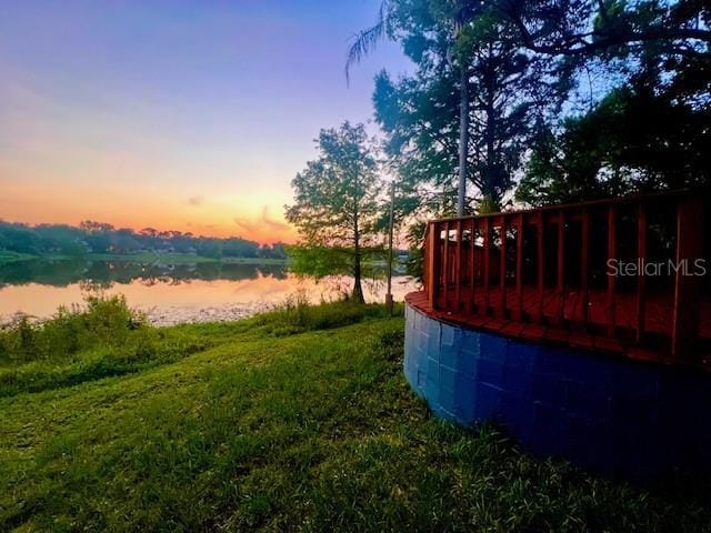 858 Lake Marion Dr, Altamonte Springs, FL 32701 - yard at dusk featuring a deck with water view