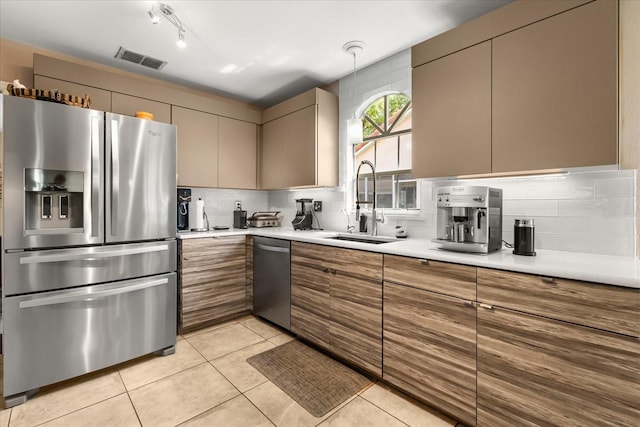 618 Via Milano, Apopka, FL 32712 - kitchen featuring visible vents, a sink, backsplash, light countertops, and appliances with stainless steel finishes