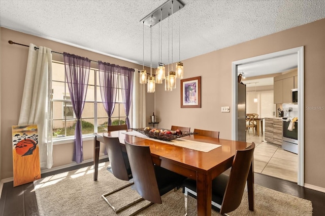 618 Via Milano, Apopka, FL 32712 - dining area with an inviting chandelier, a textured ceiling, and baseboards