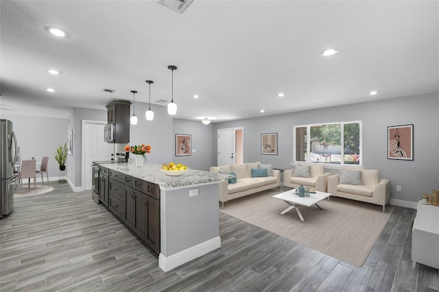 607 Wavecrest Dr, Orlando, FL 32807 - kitchen featuring open floor plan, recessed lighting, light wood-style floors, and appliances with stainless steel finishes
