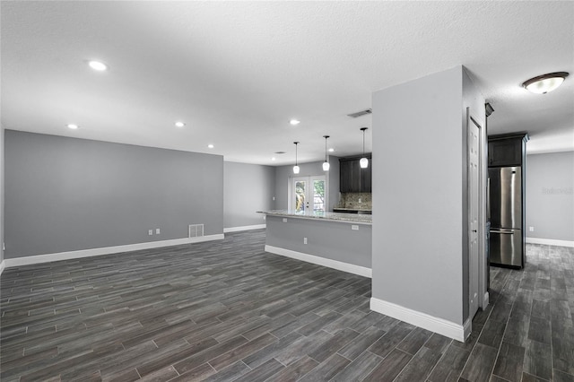 607 Wavecrest Dr, Orlando, FL 32807 - unfurnished living room featuring baseboards, visible vents, recessed lighting, and dark wood finished floors