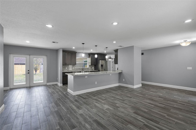 607 Wavecrest Dr, Orlando, FL 32807 - kitchen with dark wood-style floors, a peninsula, tasteful backsplash, and stainless steel refrigerator with ice dispenser
