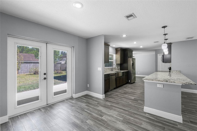 607 Wavecrest Dr, Orlando, FL 32807 - kitchen with tasteful backsplash, dark wood-style flooring, stainless steel appliances, a sink, and visible vents
