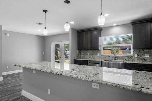 607 Wavecrest Dr, Orlando, FL 32807 - kitchen featuring decorative backsplash, baseboards, dark wood finished floors, a sink, and french doors