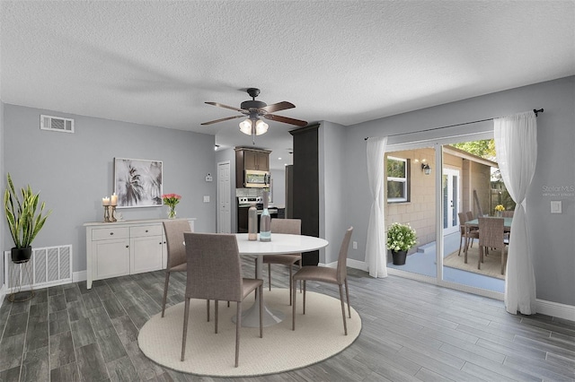 607 Wavecrest Dr, Orlando, FL 32807 - dining area featuring baseboards, visible vents, a ceiling fan, and dark wood-style flooring