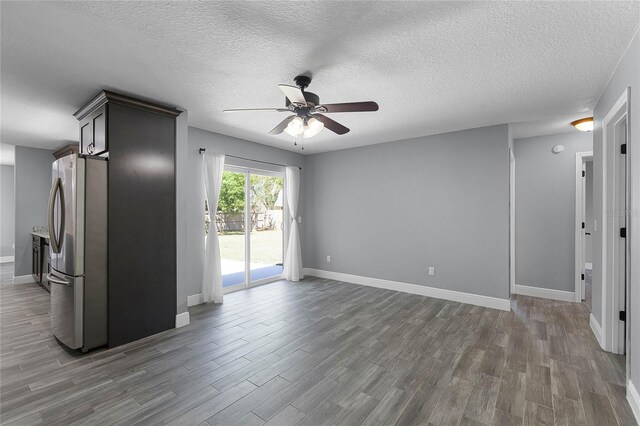 607 Wavecrest Dr, Orlando, FL 32807 - unfurnished living room featuring a ceiling fan, a textured ceiling, baseboards, and wood finished floors