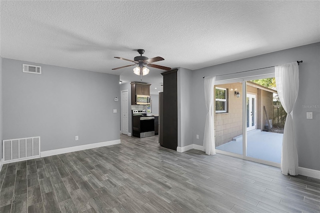 607 Wavecrest Dr, Orlando, FL 32807 - unfurnished living room with baseboards, dark wood-style flooring, ceiling fan, and visible vents