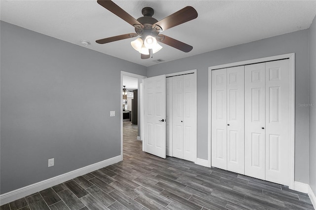 607 Wavecrest Dr, Orlando, FL 32807 - unfurnished bedroom featuring baseboards, multiple closets, and dark wood finished floors
