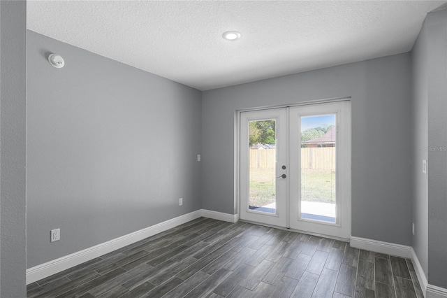 607 Wavecrest Dr, Orlando, FL 32807 - empty room featuring baseboards, a textured ceiling, french doors, and dark wood-style flooring